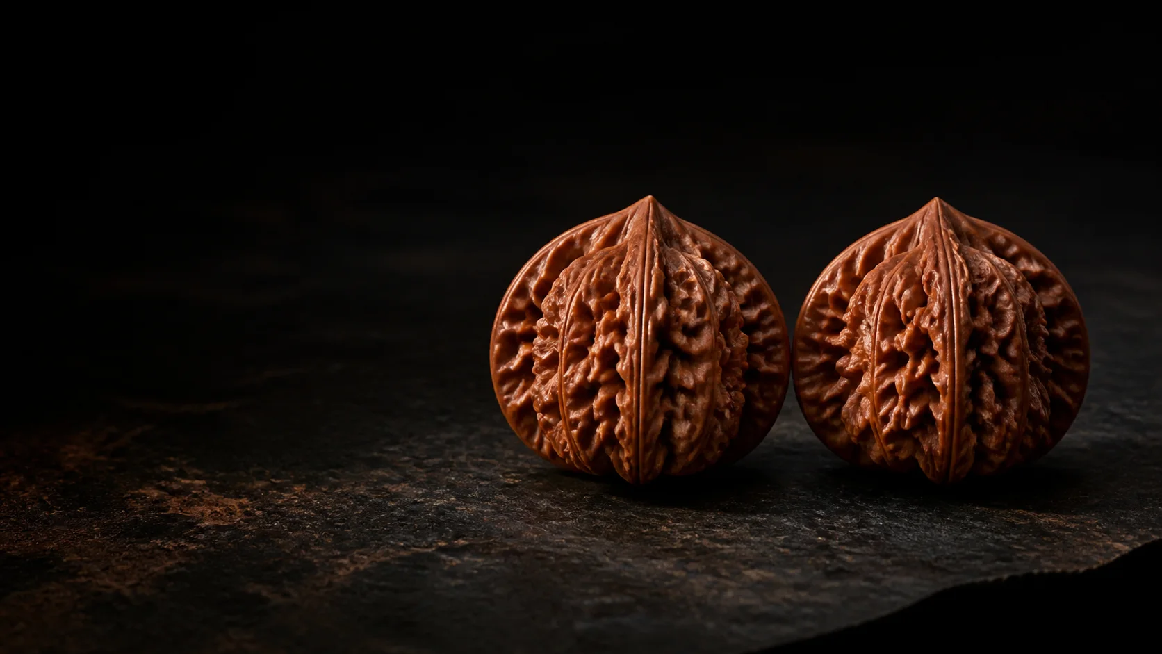 Matched pair of Wenwan walnuts on dark stone — AI placeholder